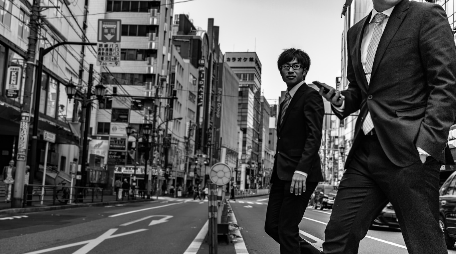 man in suit passing on the road